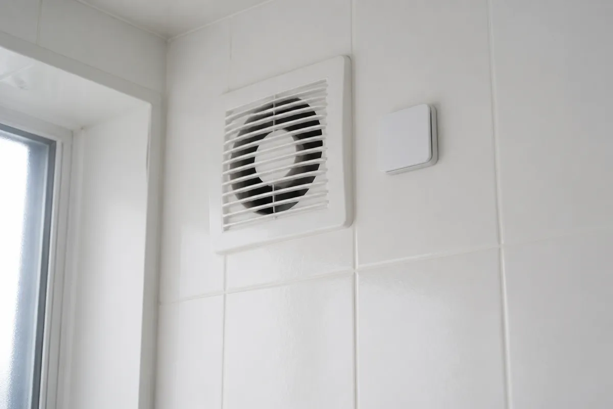 Baño moderno con extractor y sensor de humedad en pared